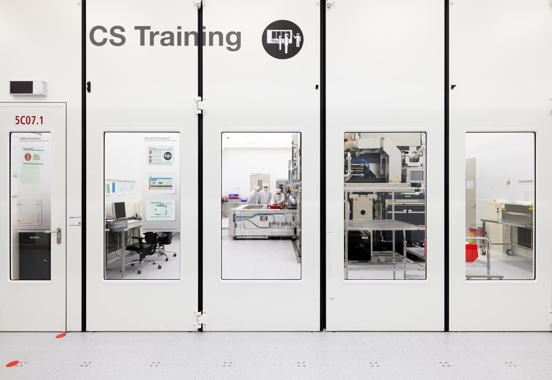 Engineers working together in a cleanroom Engineers working together in a cleanroom