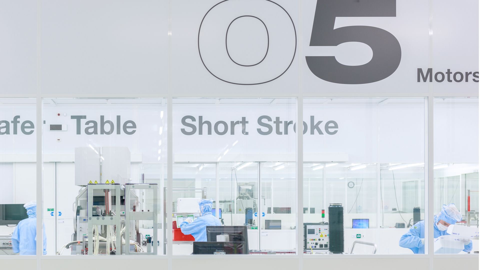 ASML employees working in a cleanroom ASML employees working in a cleanroom