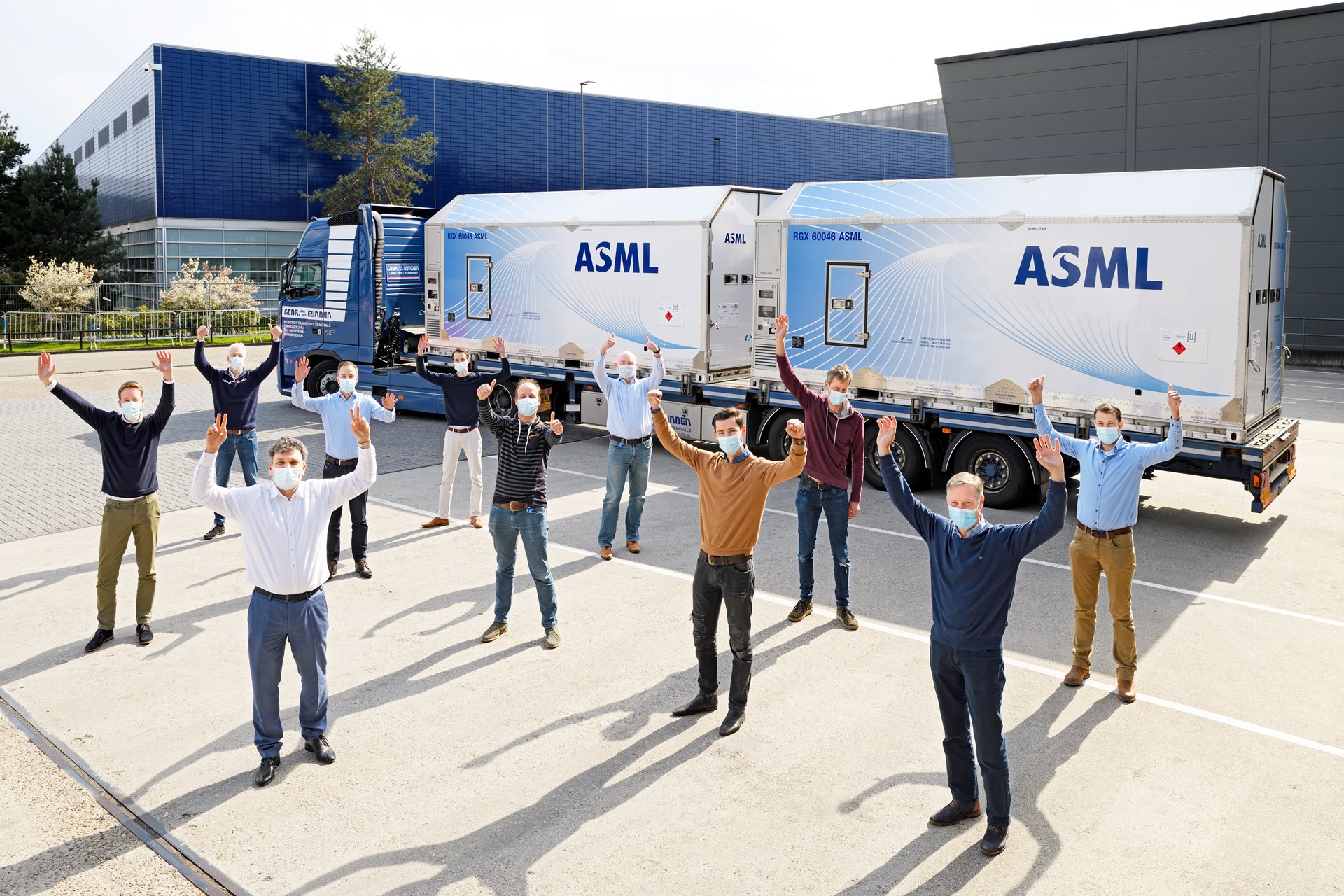 ASML engineers celebrate first shipment through pilot program, stand before system on the truck. ASML engineers celebrate first shipment through pilot program, stand before system on the truck.