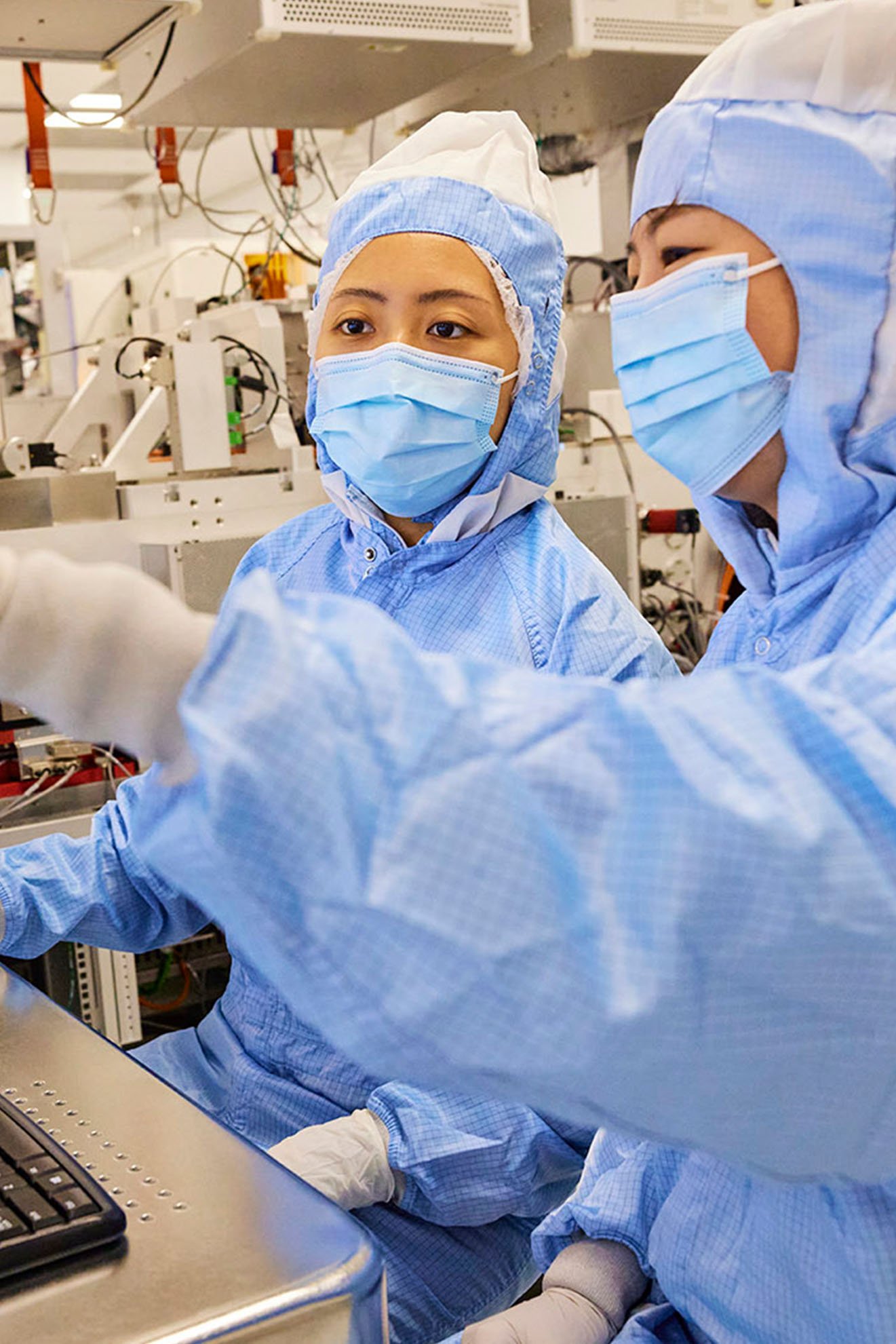 Two women work on a computer in ASML Silicon Valley.