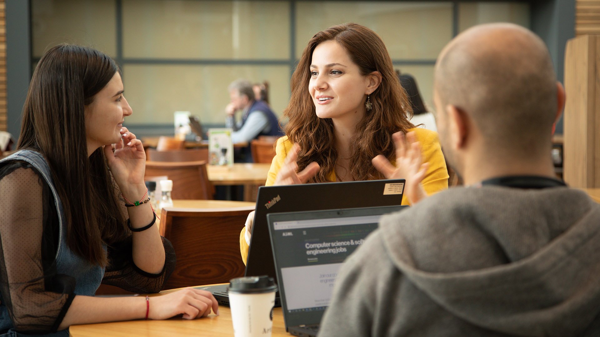 Software architect Melis Ozgur talks with colleagues at ASML in Veldhoven, the Netherlands.