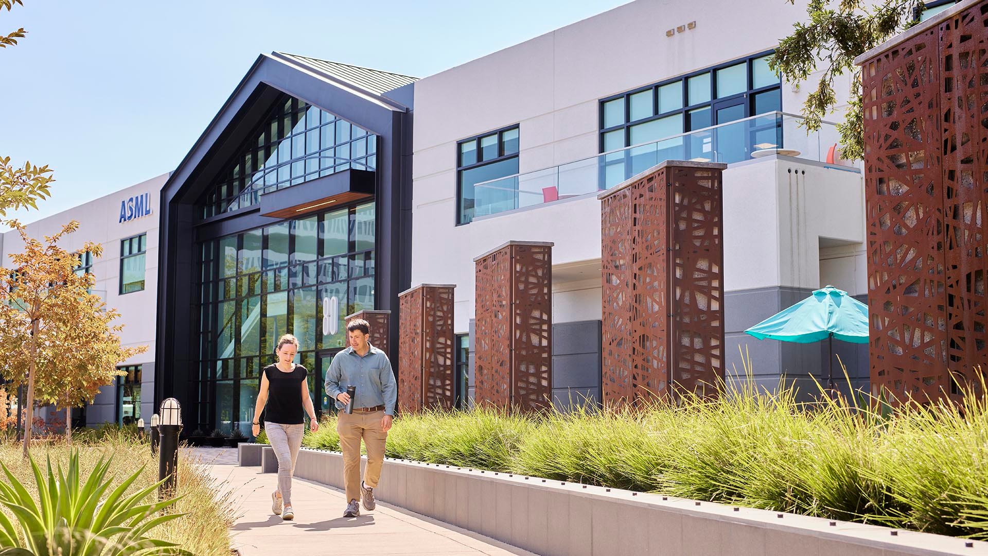 Employees walking in front of new Silicon Valley building Employees walking in front of new Silicon Valley building
