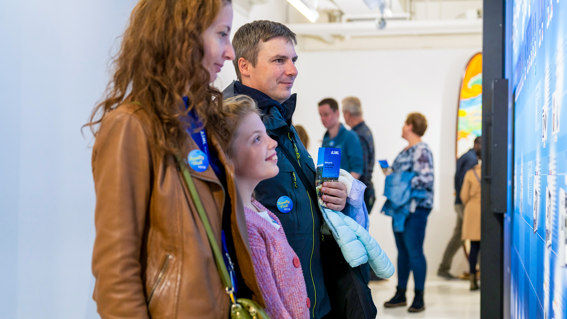 An ASML technician carefully adjusts complex equipment. An ASML technician carefully adjusts complex equipment.