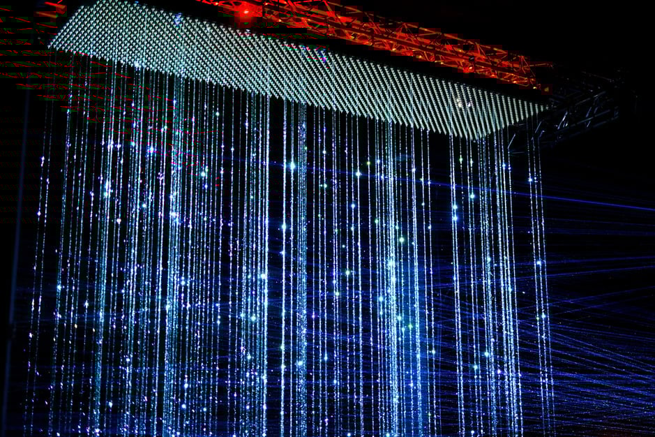 ASML’s commissioned piece for GLOW 2021, light falling in sparkling strings from the sky. ASML’s commissioned piece for GLOW 2021, light falling in sparkling strings from the sky.