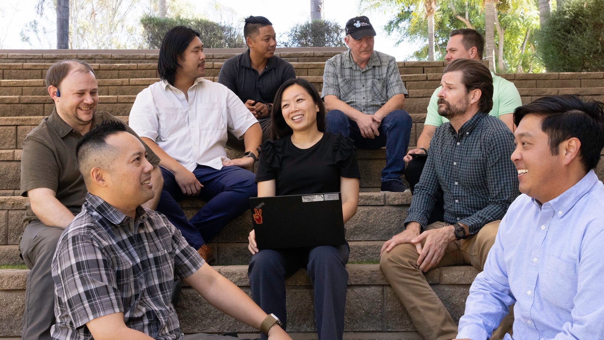 A diverse group of veterans sitting outside ASML Building 9 in San Diego, California.