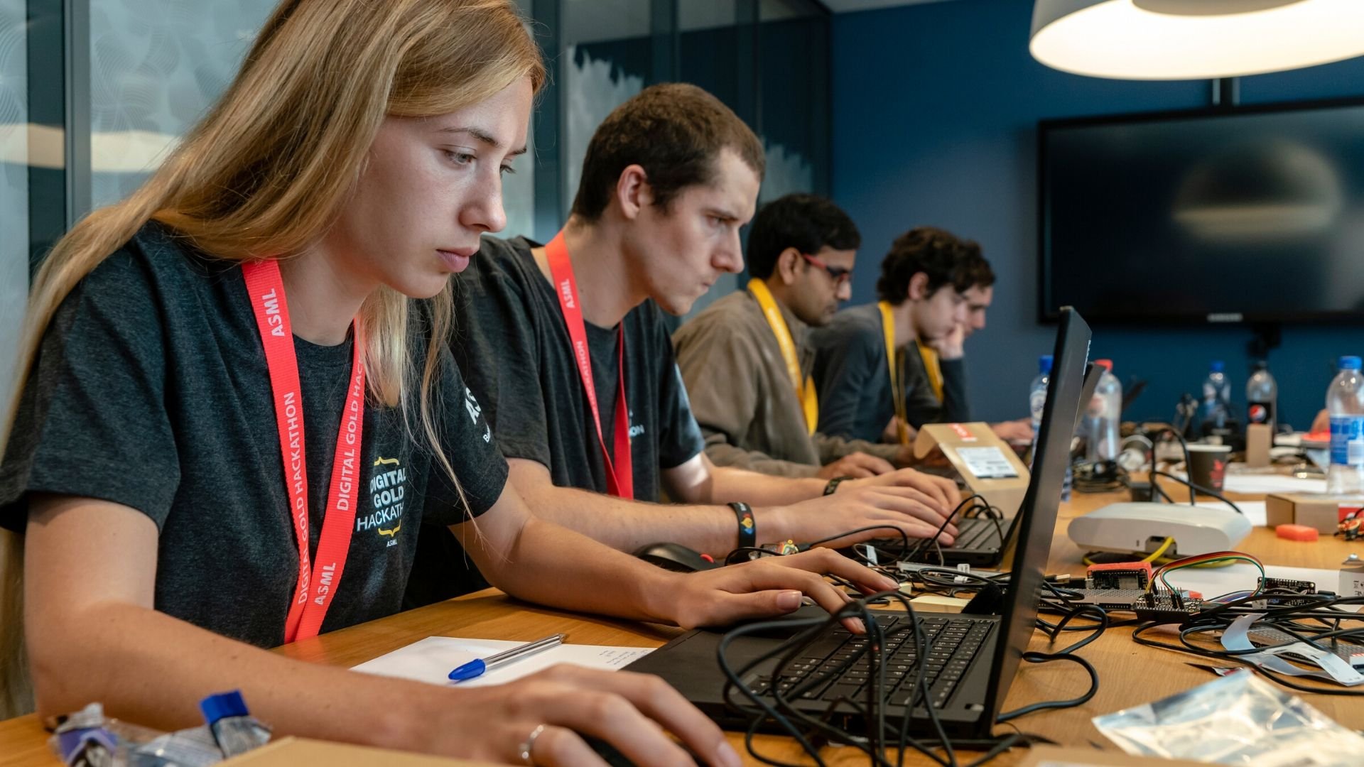 Software developers sit at a table to code during ASML's Digital Gold Hackathon in October 2018. Software developers sit at a table to code during ASML's Digital Gold Hackathon in October 2018.