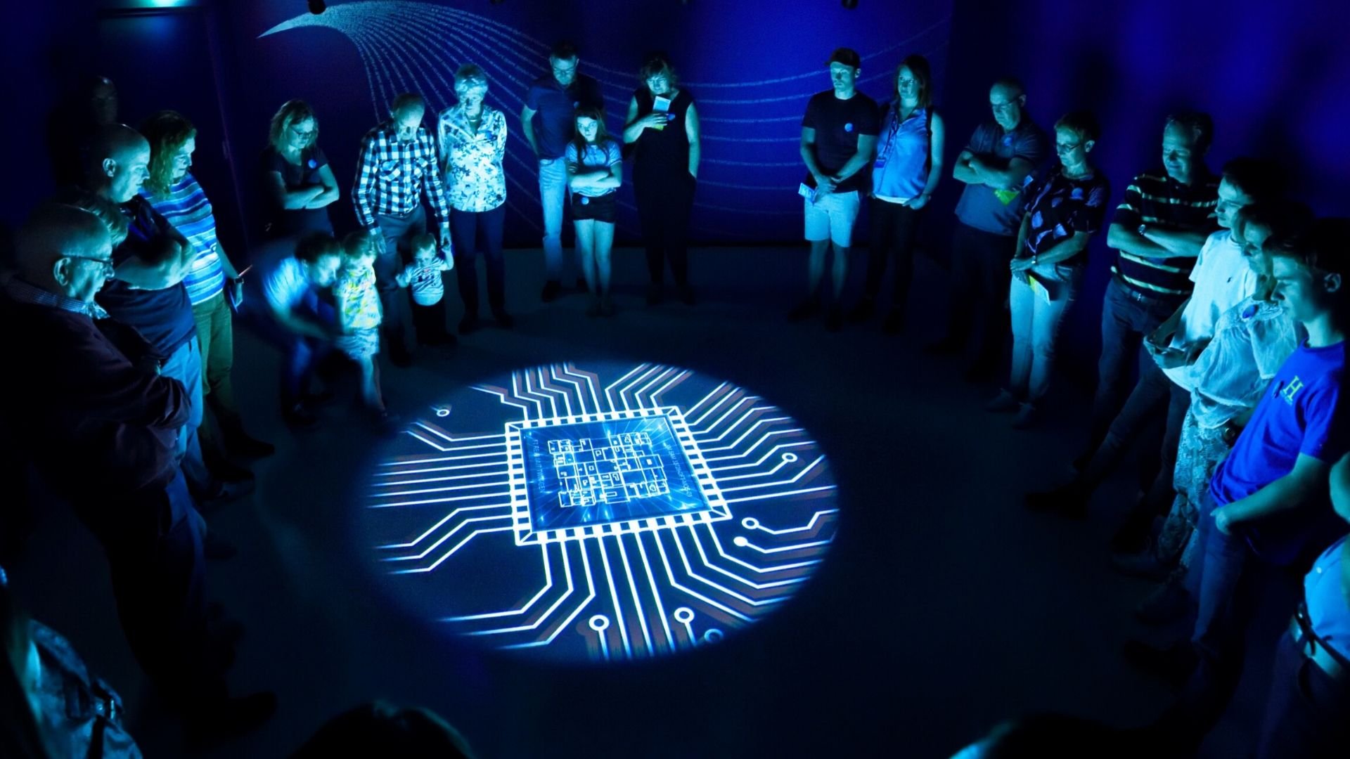 People stand to watch a video in the ASML Experience Center in Veldhoven, the Netherlands.
