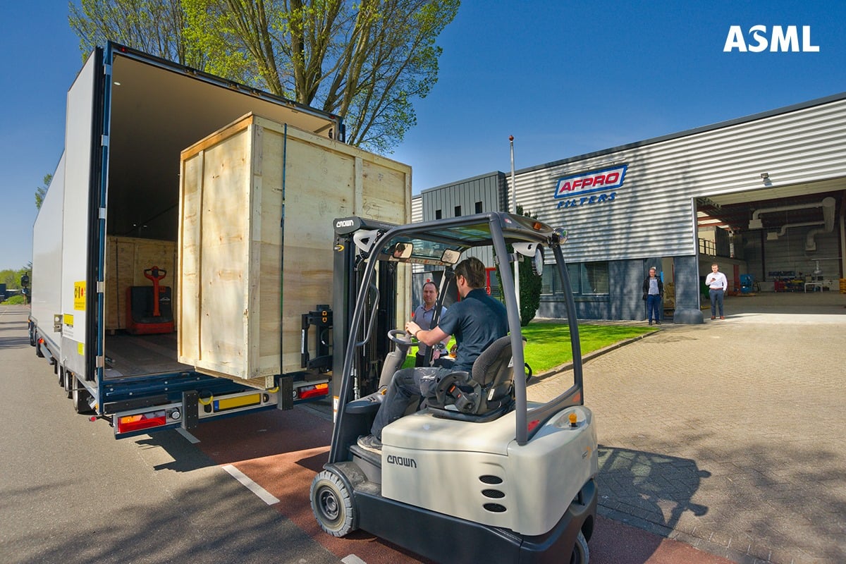man in forklift moving large box of PPE into truck for COVID-19 aid man in forklift moving large box of PPE into truck for COVID-19 aid