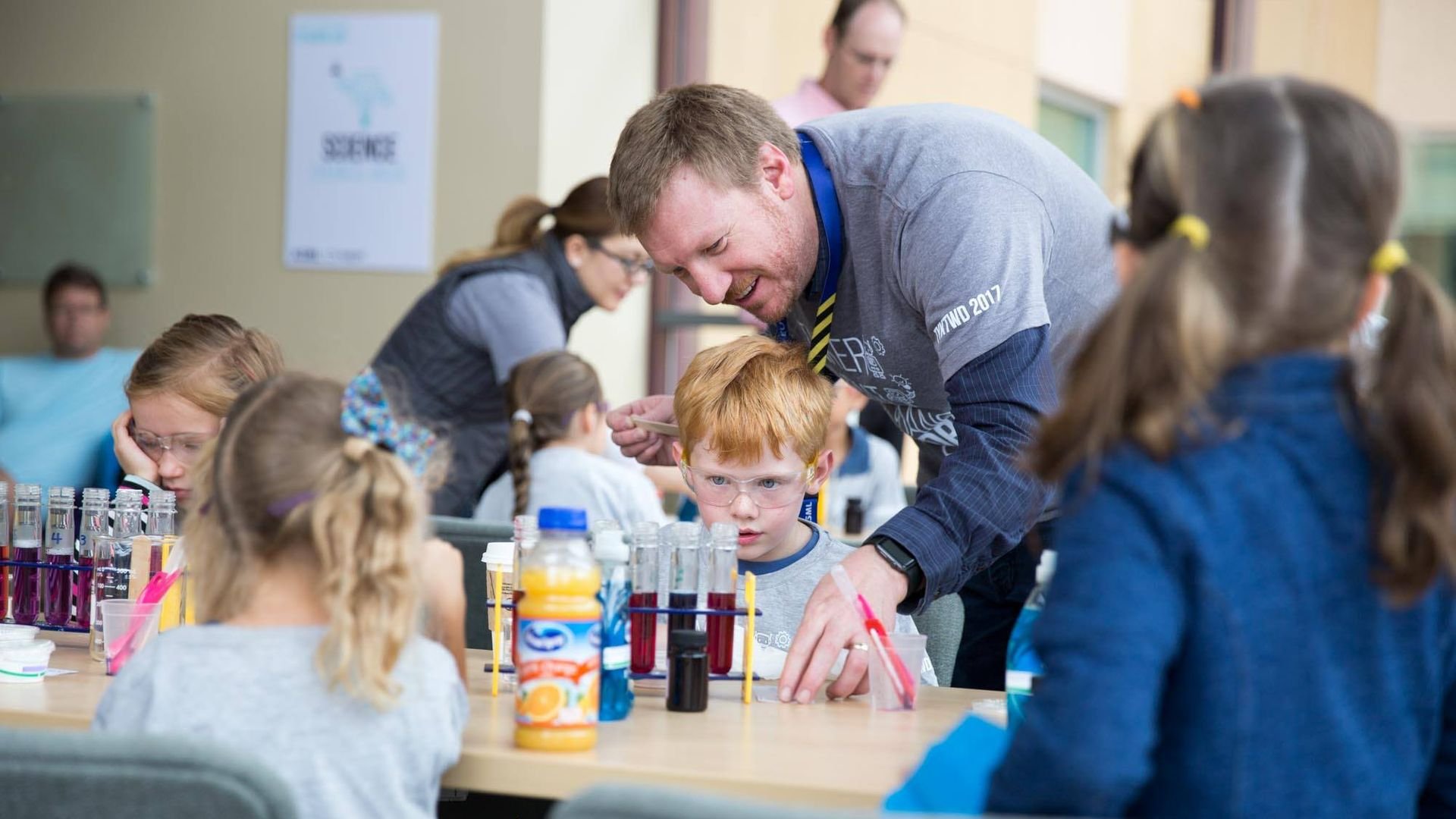 Technology promotion STEM engineer helping kids experiments chemisty physics