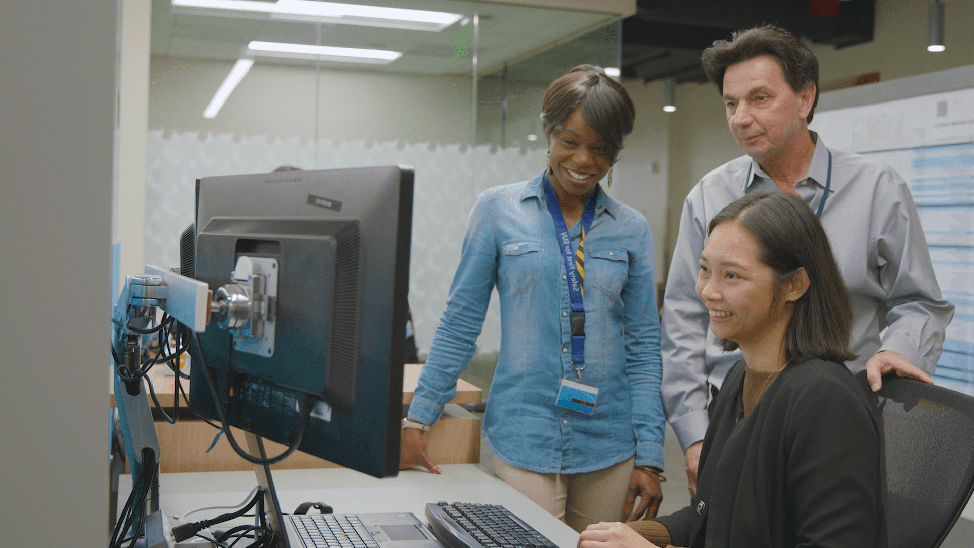 ASML employees looking at computer screen